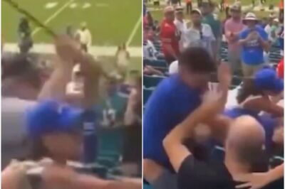 “Male & Female Buffalo Bills Fans Fight Each Other In Front Of Their Kids, Old Man Starts Swinging His Cane During Bonkers Scene In The Stands At Miami”🥊What was supposed to be a day of cheering turned into a chaotic frenzy in the stands! Buffalo Bills fans lost all control, throwing punches and shouting insults as their kids watched in horror. The scene took a wild turn when an elderly man suddenly brandished his cane—not for support, but to join the fight! You won’t believe the madness that erupted at the Miami stadium that day!k